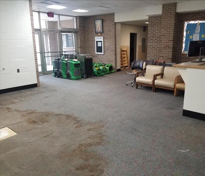 Front lobby of a university with severe water damage on the floors