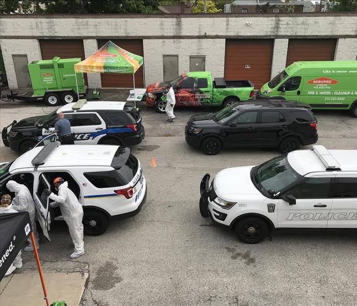 Police Vehicles lined up getting their vehicles fogged for a preventive cleaning.