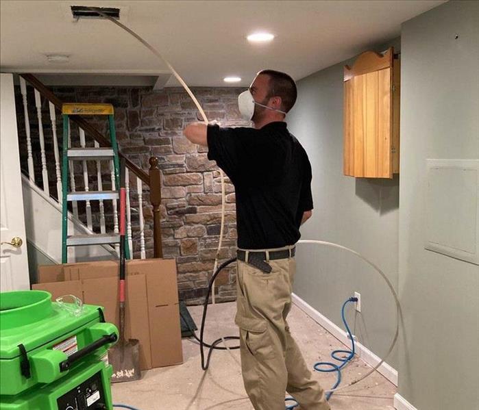 Team member cleaning air vents.