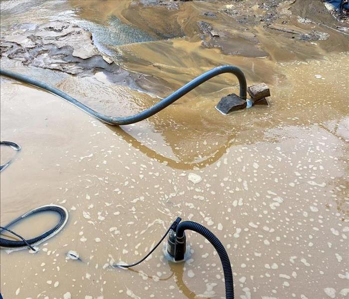 SERVPRO team removing flood water from the parking lot of a Philadelphia business