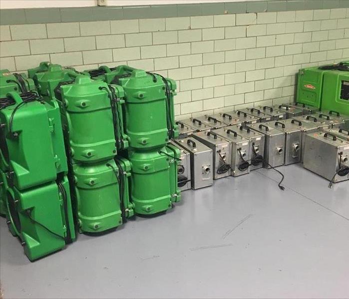 SERVPRO equipment stacked against a wall