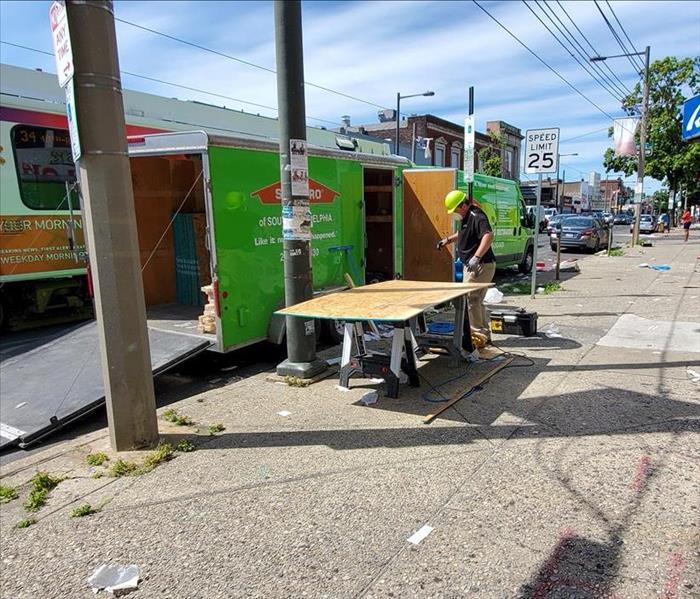 SERVPRO technician cutting plywood for a board up job in Philadelphia, PA