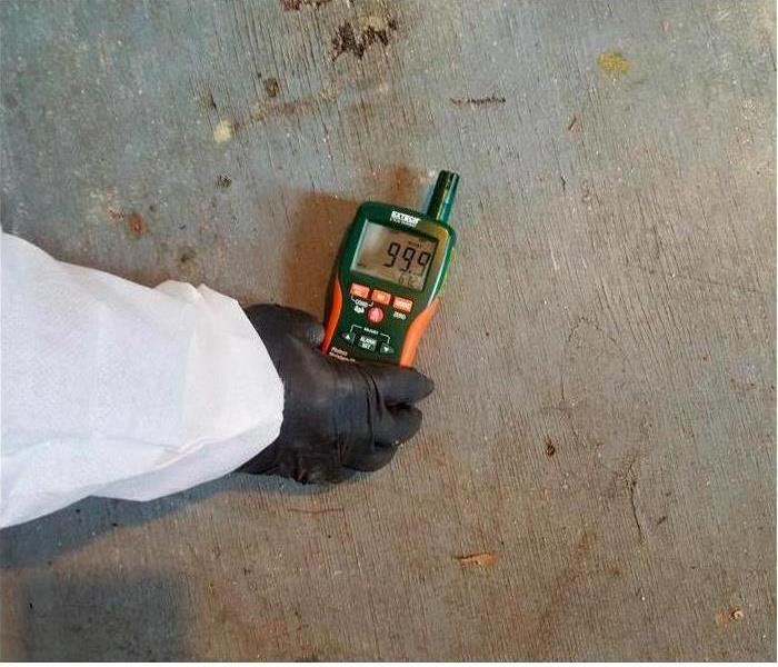 Detecting moisture with meter on a wall