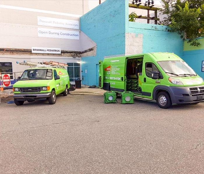 Two SERVPRO vehicles parked in front of a Collingdale, PA business